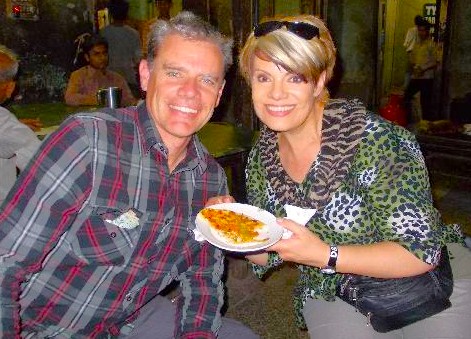 Smiling tourists savor delicious paranthas at a bustling Delhi street eatery near the historic Qutb Minar in India, capturing vibrant local cuisine, cultural heritage, atmosphere, outdoor dining, memorable travel experience. Smiling tourists savor delicious paranthas at a bustling Delhi street eatery near the historic Qutb Minar in India, capturing vibrant local cuisine, cultural heritage, atmosphere, outdoor dining, memorable travel experience.