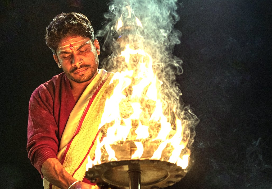 "A close-up of a Pujari in deep concentration performing the Ganga Aarti in Varanassi, India, a spiritual highlight complementing an itinerary that includes Delhi, Rajasthan, and a visit Unesco Taj mahal." "A close-up of a Pujari in deep concentration performing the Ganga Aarti in Varanassi, India, a spiritual highlight complementing an itinerary that includes Delhi, Rajasthan, and a visit Unesco Taj mahal."