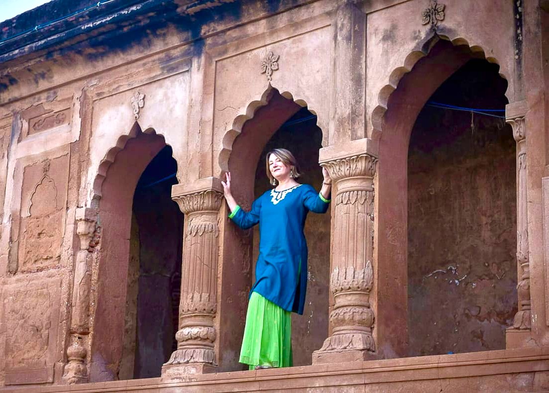 “Female tourist in vibrant traditional attire exploring ornate Mughal sandstone arches and carved balcony at historic Fatehpur Sikri Agra India heritage site, showcasing culture architecture.” “Female tourist in vibrant traditional attire exploring ornate Mughal sandstone arches and carved balcony at historic Fatehpur Sikri Agra India heritage site, showcasing culture architecture.”