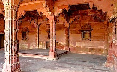 Elegant red sandstone pillars and archways in Fatehpur Sikri's historic courtyard, a UNESCO World Heritage architectural marvel in Uttar Pradesh, India, showcasing Mughal craftsmanship. Elegant red sandstone pillars and archways in Fatehpur Sikri's historic courtyard, a UNESCO World Heritage architectural marvel in Uttar Pradesh, India, showcasing Mughal craftsmanship.