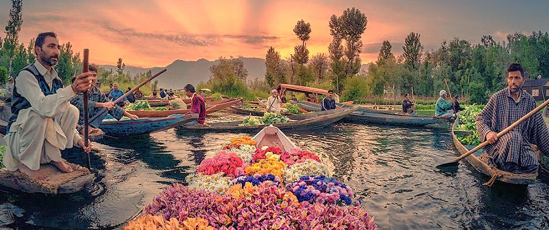 The stunning Floating Market at sunrise in Srinagar, Jammu and Kashmir, India, with local vendors selling colorful flowers and vegetables from traditional shikaras on Dal Lake.