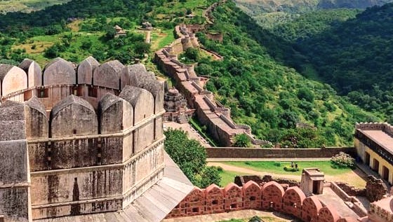 Scenic panoramic view of Kumbhalgarh Fort perched atop the Aravali Hills near Udaipur and Jodhpur in Rajasthan, India, showcasing massive stone walls, lush greenery, and serene historic ancient fortress architecture. Scenic panoramic view of Kumbhalgarh Fort perched atop the Aravali Hills near Udaipur and Jodhpur in Rajasthan, India, showcasing massive stone walls, lush greenery, and serene historic ancient fortress architecture.