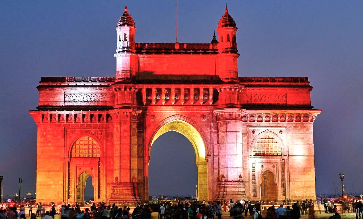 Illuminated Gateway of India arch in Colaba, Mumbai, Mahapradesh, India, overlooking Arabian Sea waterfront, evening iconic basalt monument, colonial architectural masterpiece, historical landmark, vibrant tourist destination, popular cultural heritage site. Illuminated Gateway of India arch in Colaba, Mumbai, Mahapradesh, India, overlooking Arabian Sea waterfront, evening iconic basalt monument, colonial architectural masterpiece, historical landmark, vibrant tourist destination, popular cultural heritage site.