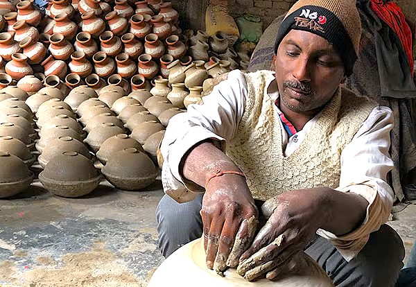 A potter crafts clay pots near Gavipuram Cave Temple in Bangalore, Karnataka, India, an artisan area near Tipu Sultan Palace ('Tiger of Mysore') for tourists near Mysore Palace. A potter crafts clay pots near Gavipuram Cave Temple in Bangalore, Karnataka, India, an artisan area near Tipu Sultan Palace ('Tiger of Mysore') for tourists near Mysore Palace.