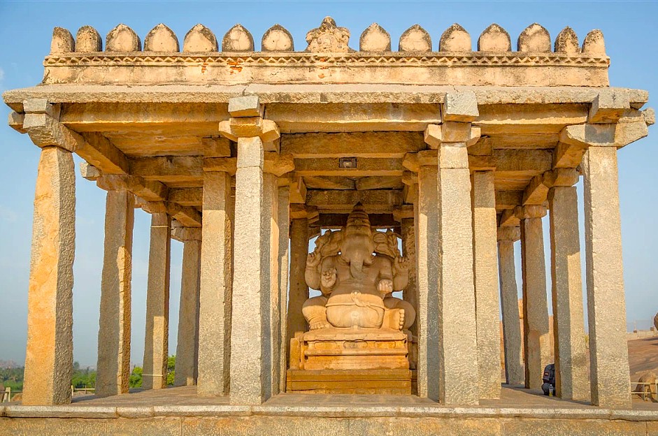 This monolithic Ganesha statue is a famous monument at the Hampi Unesco site in Karnataka, India, which also includes the royal Elephant stables and the historic queens baths.