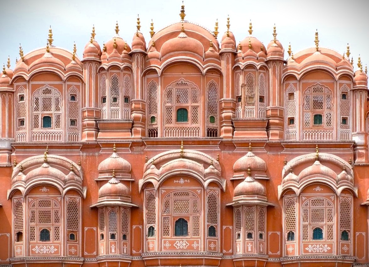 Iconic UNESCO-listed Jaipur’s Hawa Mahal (Palace of the Winds) landmark in Rajasthan, India, showcases ornate pink sandstone façade, intricate lattice jharokhas, domed balconies, Indo-Islamic Mughal architecture, royal legacy heritage site.