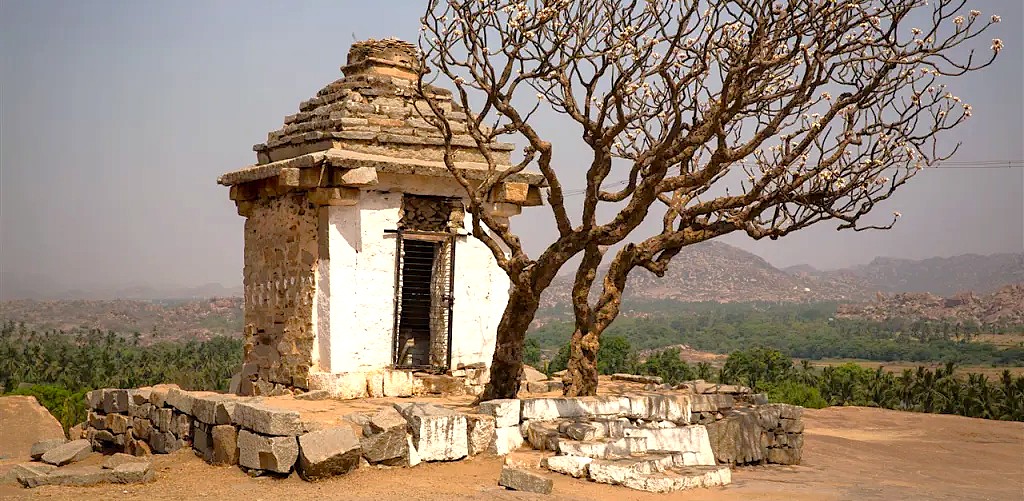 The shrine on Hemakuta Hill overlooks the Queens' Bath, Elephant Stables, and Kadalekalu Ganesha ruins at Hampi, Karnataka, India's UNESCO site. The shrine on Hemakuta Hill overlooks the Queens' Bath, Elephant Stables, and Kadalekalu Ganesha ruins at Hampi, Karnataka, India's UNESCO site.