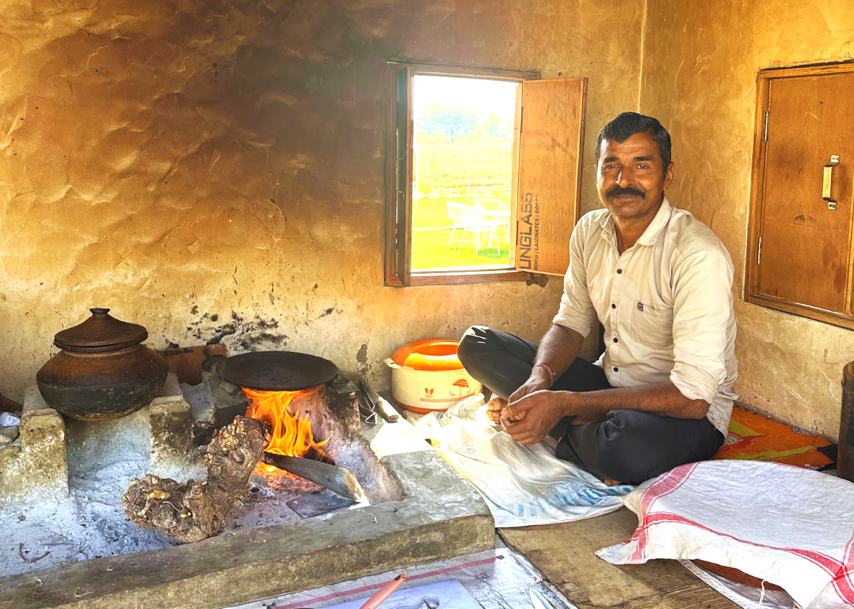 A local man prepares traditional food on a wood fire in India, a glimpse of life near the Hichappayya Gudi temple, Badami, and the Pattadakal UNESCO temples. A local man prepares traditional food on a wood fire in India, a glimpse of life near the Hichappayya Gudi temple, Badami, and the Pattadakal UNESCO temples.