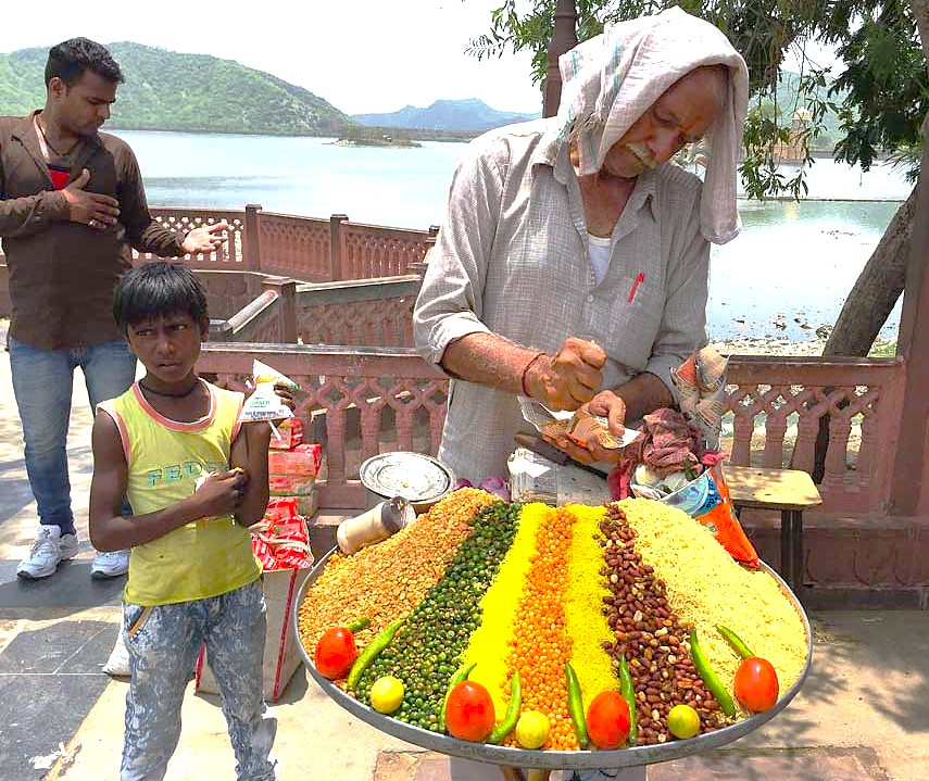 A street food vendor serves snacks near Hippie Island in Hampi, a UNESCO site in Karnataka, India, close to Sanapur Lake, Vittala Temple, and the Queen's Baths. A street food vendor serves snacks near Hippie Island in Hampi, a UNESCO site in Karnataka, India, close to Sanapur Lake, Vittala Temple, and the Queen's Baths.