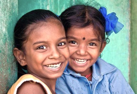 Two smiling local Indian girls in Delhi, India, seen near Humayun's Tomb, a UNESCO World Heritage site, and other landmarks like the Red Fort and Qutub Minar. Two smiling local Indian girls in Delhi, India, seen near Humayun's Tomb, a UNESCO World Heritage site, and other landmarks like the Red Fort and Qutub Minar.