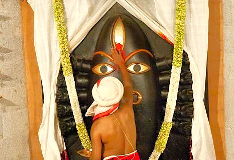 “Devotee performing solemn ritual at the sacred Shiva Linga shrine inside Isha Temple Coimbatore, Tamil Nadu, India, surrounded by vibrant floral garlands and traditional offerings.”  “Devotee performing solemn ritual at the sacred Shiva Linga shrine inside Isha Temple Coimbatore, Tamil Nadu, India, surrounded by vibrant floral garlands and traditional offerings.”