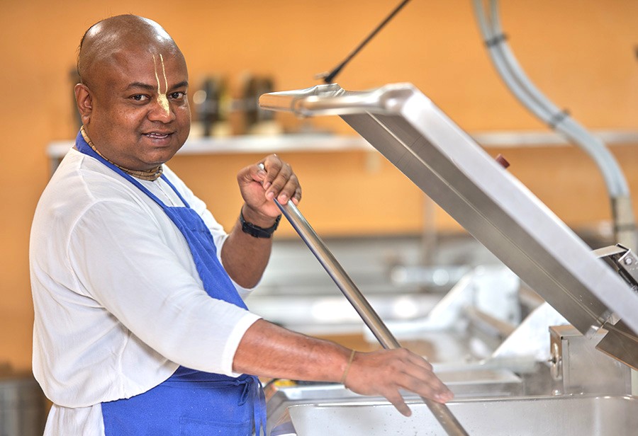 A devotee prepares fresh prasadam inside the industrial kitchen of the spiritual ISKCON temple Bangalore, a renowned cultural destination in Karnataka, India, located near the historic Mysore Palace. A devotee prepares fresh prasadam inside the industrial kitchen of the spiritual ISKCON temple Bangalore, a renowned cultural destination in Karnataka, India, located near the historic Mysore Palace.