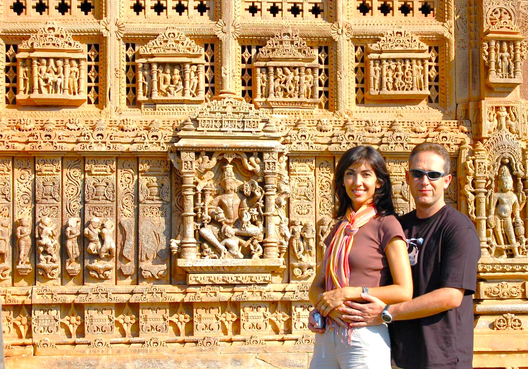 Smiling couple embrace before intricate marble carvings at Jag Mandir, Udaipur, Rajasthan, India, exploring historic palace architecture, connecting with local artisans, vibrant culture, serene lake views, and timeless spiritual legacy. Smiling couple embrace before intricate marble carvings at Jag Mandir, Udaipur, Rajasthan, India, exploring historic palace architecture, connecting with local artisans, vibrant culture, serene lake views, and timeless spiritual legacy.