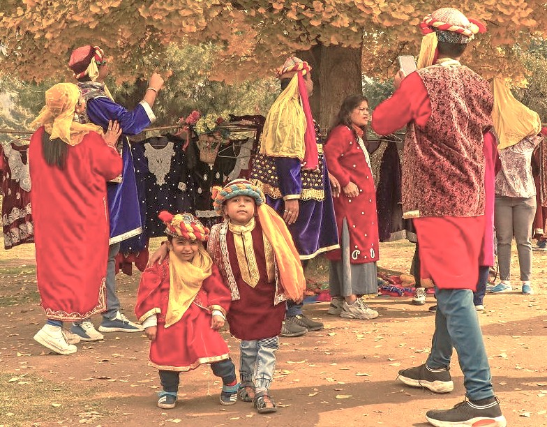 A Kashmiri family wearing vibrant traditional clothing poses near Srinagar, India, beneath autumn trees, symbolizing the rich culture of the Himalayas near Shankaracharya Hill and the controversial Jesus Tomb, though the city is not a Unesco City of Arts. A Kashmiri family wearing vibrant traditional clothing poses near Srinagar, India, beneath autumn trees, symbolizing the rich culture of the Himalayas near Shankaracharya Hill and the controversial Jesus Tomb, though the city is not a Unesco City of Arts.