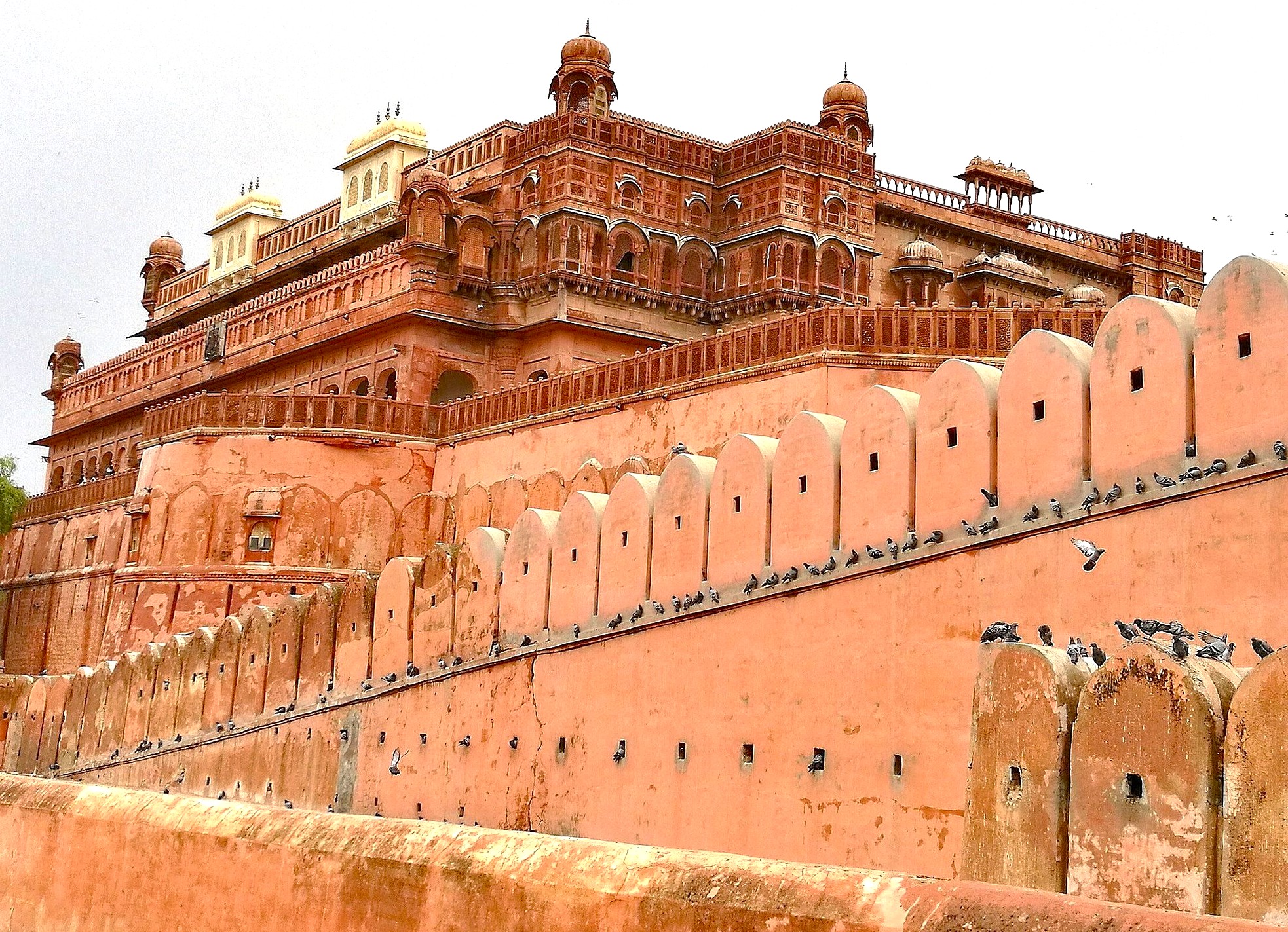 A sweeping view of Junagarh Fort Bikaner showcases ornate sandstone palaces and imposing ramparts in Rajasthan, India, amid the golden dunes of the Thar Desert, reflecting royal heritage and resilience. A sweeping view of Junagarh Fort Bikaner showcases ornate sandstone palaces and imposing ramparts in Rajasthan, India, amid the golden dunes of the Thar Desert, reflecting royal heritage and resilience.