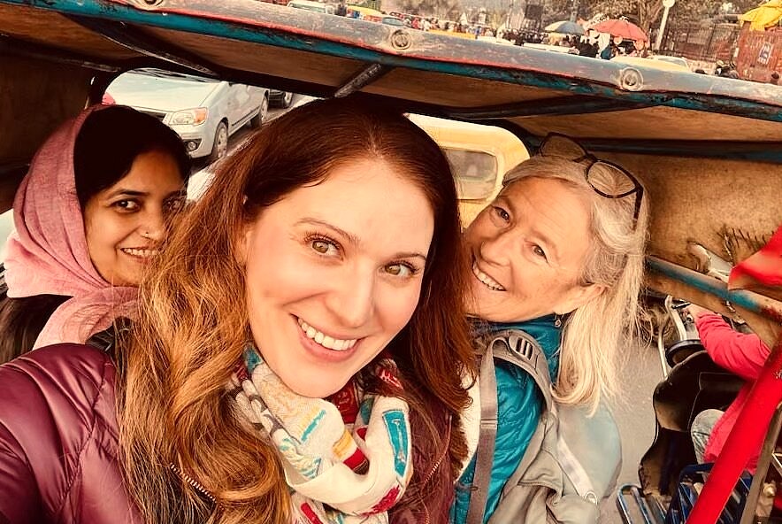 Three smiling women enjoy shared transport near the Kadalekalu Ganesha, capturing the vibrant travel experience at the UNESCO site of Hampi, Karnataka, India. Three smiling women enjoy shared transport near the Kadalekalu Ganesha, capturing the vibrant travel experience at the UNESCO site of Hampi, Karnataka, India.
