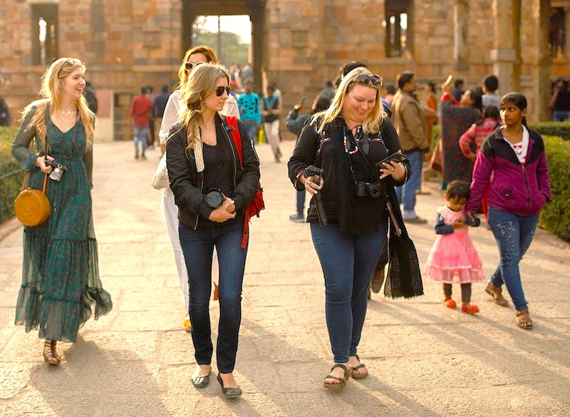 Group of tourists exploring Kailasa Temple at Ellora Caves near Aurangabad, Maharashtra, India, part of the UNESCO-listed Ellora and Ajanta Caves complex, capturing vibrant historical architecture and rich cultural heritage.