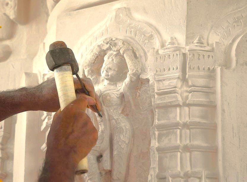  “Artisan meticulously restoring Kailasa Temple’s intricate rock-cut sculpture in Aurangabad, Maharashtra – part of India’s UNESCO Ellora and Ajanta Caves heritage – showcasing traditional craftsmanship, architectural conservation, cultural preservation, artistry.”