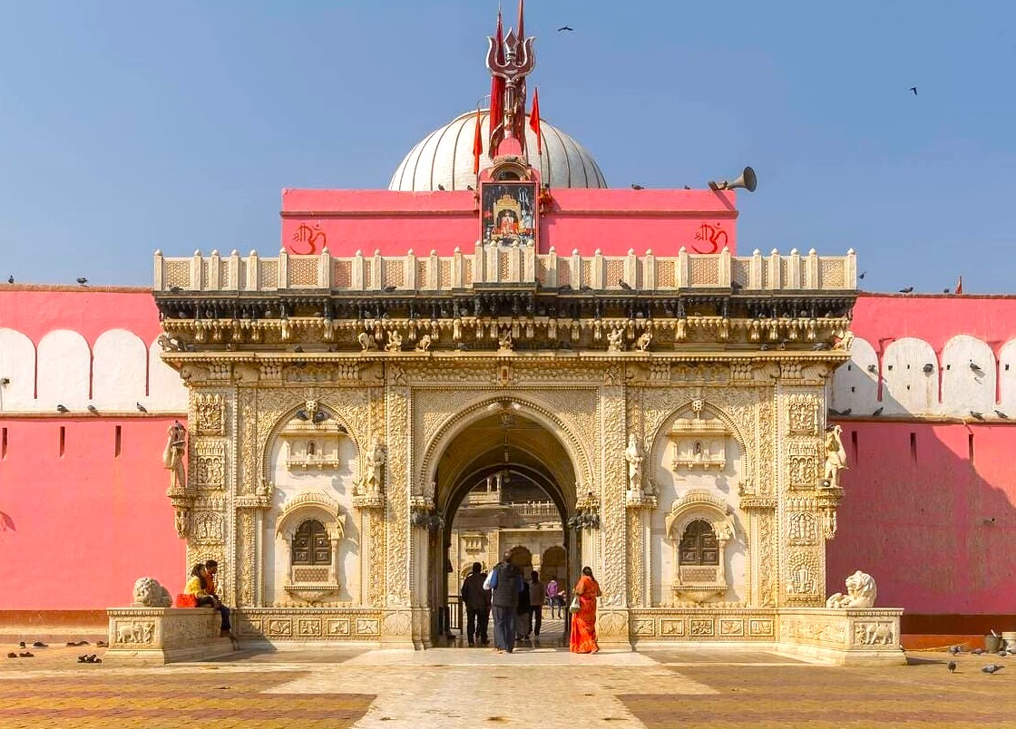  Ornate majestic pink and white temple entrance in Bikaner Thar Desert, Rajasthan, India, invites pilgrims into the sacred Karni Mata sanctuary, showcasing intricate carvings, rich heritage, and traditional spiritual architecture.