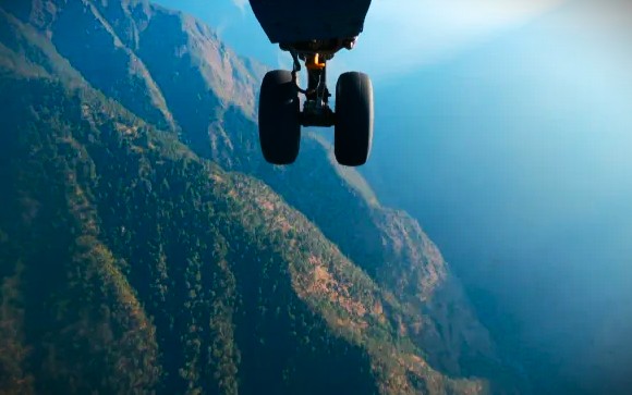 Dramatic view of an aircraft landing over the Himalayan peaks near Srinagar, signaling the exciting start of a thrilling adventure exploring Pahalgam, Betaab and Aru Valleys, the vast heights of Sinthan Top, and the rich nature of Dachigam National Park.