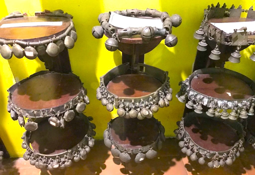 Intricately crafted antique metallic ankle bells and tambourines displayed at the Kerala Folklore Museum Kochi exemplify South India’s Kerala folk heritage, musical percussion instruments, museum collection preserving regional cultural traditions. Intricately crafted antique metallic ankle bells and tambourines displayed at the Kerala Folklore Museum Kochi exemplify South India’s Kerala folk heritage, musical percussion instruments, museum collection preserving regional cultural traditions.