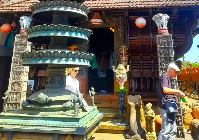 Tourists exploring ornate, detailed stone carvings at the entrance of Kerala Folklore Museum in Kochi, South India, showcasing traditional Kerala temple architecture and immersive cultural artifacts amid vibrant heritage displays. Tourists exploring ornate, detailed stone carvings at the entrance of Kerala Folklore Museum in Kochi, South India, showcasing traditional Kerala temple architecture and immersive cultural artifacts amid vibrant heritage displays.