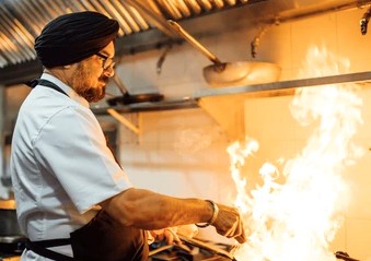 Smiling woman relaxing atop a pile of fresh coconuts near the historic Saint Francis Church in Kochi, Kerala, South India, showcasing local agriculture, tropical scenery, and vibrant rich cultural heritage. Smiling woman relaxing atop a pile of fresh coconuts near the historic Saint Francis Church in Kochi, Kerala, South India, showcasing local agriculture, tropical scenery, and vibrant rich cultural heritage.