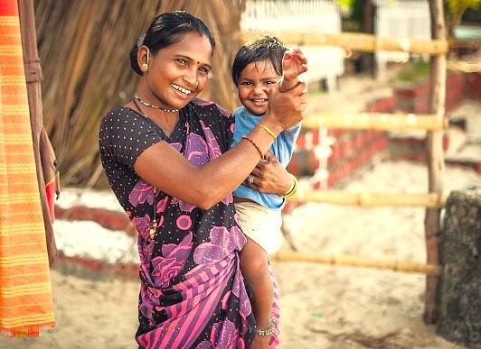 The loving relationship between a mother and child is supported by the Smokeless Stove Project from Kids Health India, a vital initiative in regions tourists visit like Kodaikanal, Madurai, Meenakshi Temple in Tamil Nadu, and Munnar near the Unesco Western Ghats.