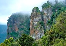 Scenic Pillar Rocks cliffs in Kodaikanal’s misty Palani Hills, Tamil Nadu, South India backdrop inspires Kids Health India Smokeless Stove Project awareness and health improvement.