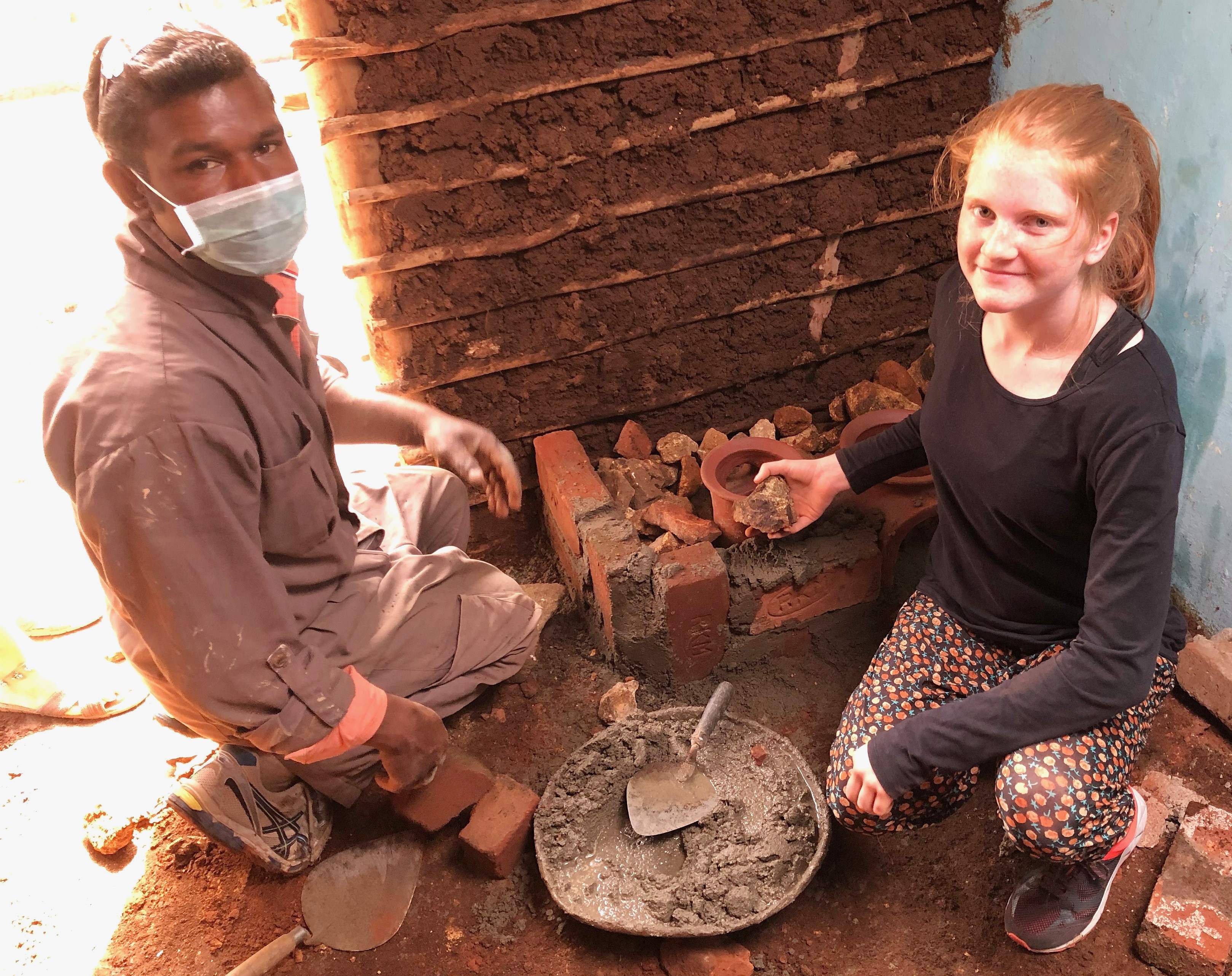 Volunteers from the Kids Health India Smokeless Stove Project build a brick and mortar community smokeless stove in Kodaikanal, Palani Hills, Tamil Nadu, South India.