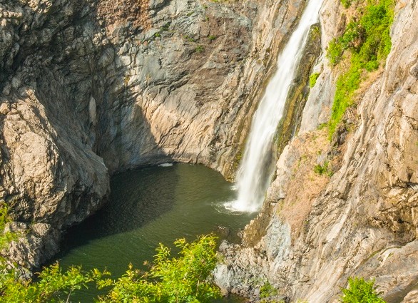 Spectacular waterfall cascades into a serene pool amid rugged cliffs and greenery in the Palani Hills near Kodaikanal, Tamil Nadu, South India’s misty highland paradise.