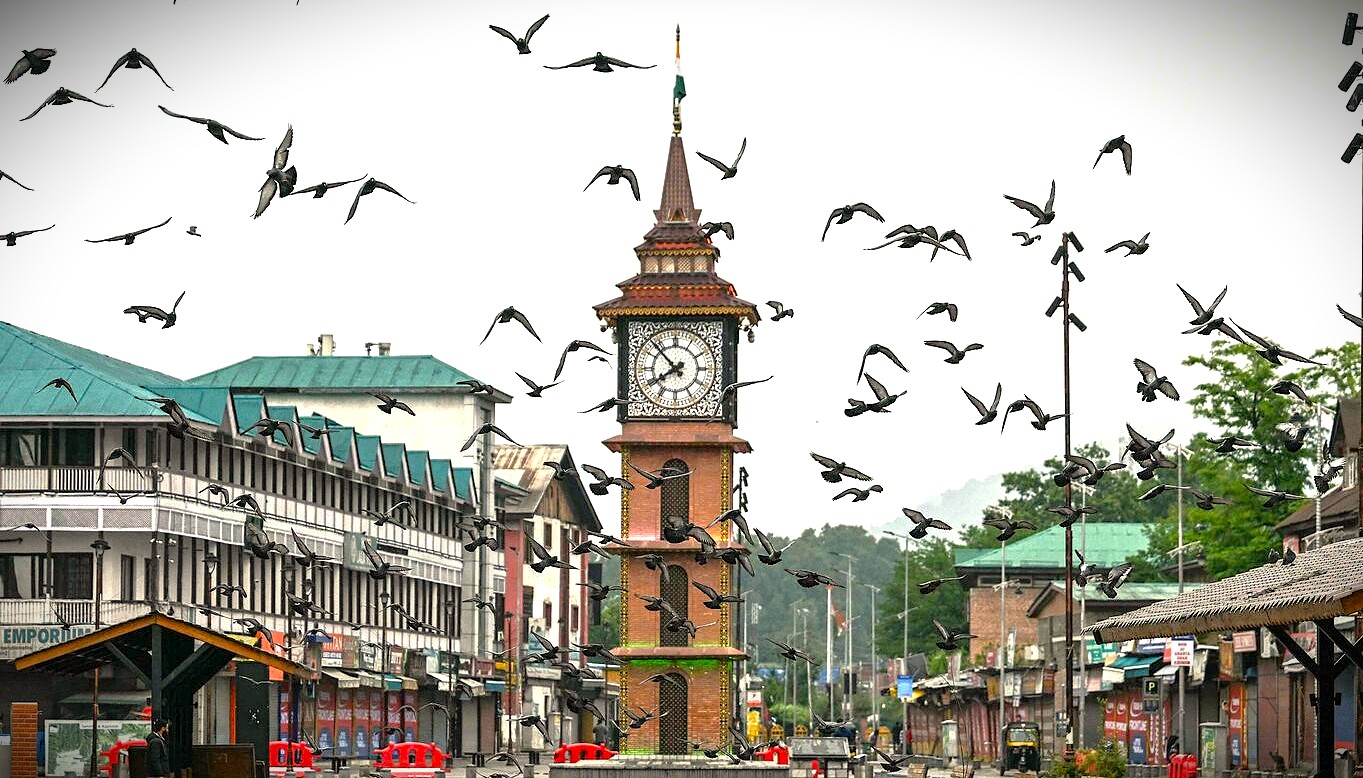 Pigeons fly around the iconic clock tower in Lal Chowk, the historic commercial heart of Srinagar, reflecting the dynamic life of this UNESCO Creative Arts city in Jammu and Kashmir, India. Pigeons fly around the iconic clock tower in Lal Chowk, the historic commercial heart of Srinagar, reflecting the dynamic life of this UNESCO Creative Arts city in Jammu and Kashmir, India.