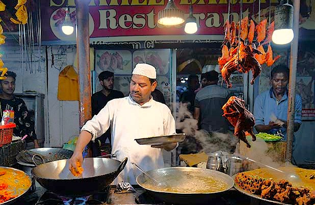 A chef prepares local street food and delicious cuisine at a bustling restaurant near Lal Chowk, celebrating the UNESCO Creative Arts food culture of Srinagar, Jammu and Kashmir, India. A chef prepares local street food and delicious cuisine at a bustling restaurant near Lal Chowk, celebrating the UNESCO Creative Arts food culture of Srinagar, Jammu and Kashmir, India.