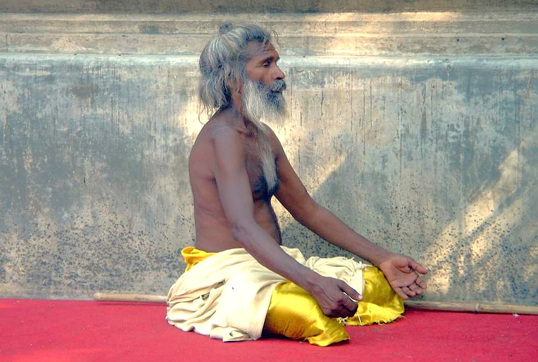 A Hindu ascetic meditates in a public space near Lal Chowk, symbolizing the diverse spiritual culture of the UNESCO Creative Arts city of Srinagar, Jammu and Kashmir, India. A Hindu ascetic meditates in a public space near Lal Chowk, symbolizing the diverse spiritual culture of the UNESCO Creative Arts city of Srinagar, Jammu and Kashmir, India.