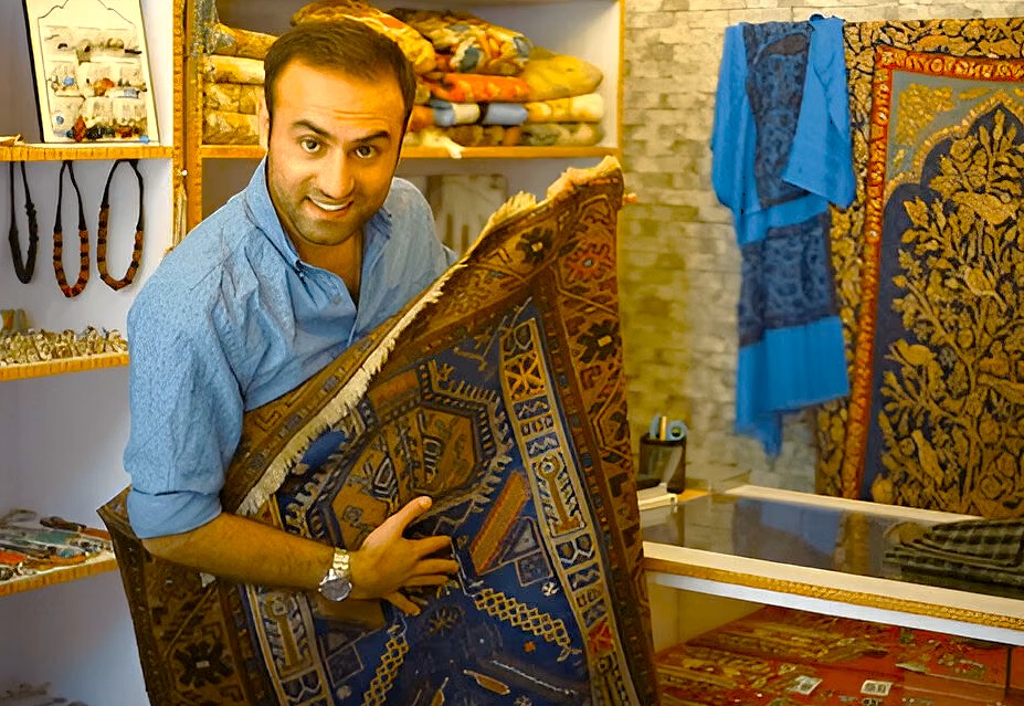 A smiling vendor displays a beautiful Kashmiri carpet inside a shop near Lal Chowk, showcasing the city's UNESCO Creative Arts tradition in Srinagar, Jammu and Kashmir, India. A smiling vendor displays a beautiful Kashmiri carpet inside a shop near Lal Chowk, showcasing the city's UNESCO Creative Arts tradition in Srinagar, Jammu and Kashmir, India.