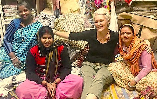 A smiling tourist poses with local women artisans inside a textile shop near Lal Chowk, celebrating Srinagar's UNESCO Creative Arts culture in Jammu and Kashmir, India. A smiling tourist poses with local women artisans inside a textile shop near Lal Chowk, celebrating Srinagar's UNESCO Creative Arts culture in Jammu and Kashmir, India.