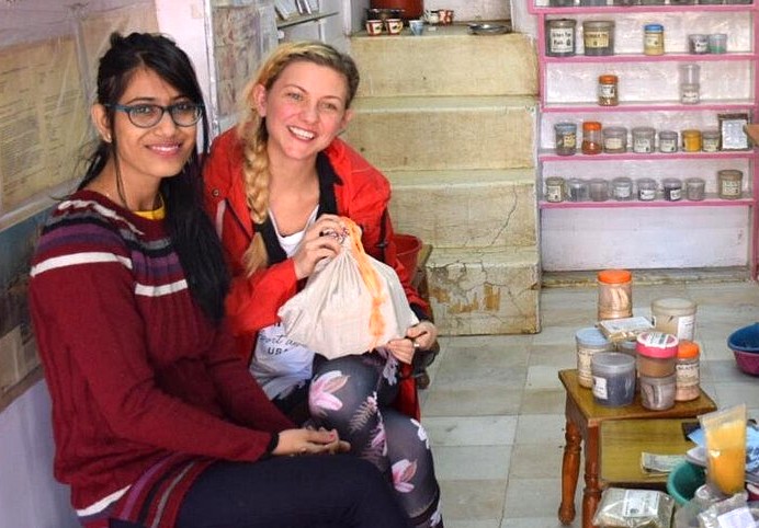 Two travellers sample aromatic Rajasthani spices in a Udaipur market stall near Lake Pichola during a serene Shikara boat tour in Rajasthan, India, discovering vibrant flavors, local craftsmanship, authentic souvenirs. Two travellers sample aromatic Rajasthani spices in a Udaipur market stall near Lake Pichola during a serene Shikara boat tour in Rajasthan, India, discovering vibrant flavors, local craftsmanship, authentic souvenirs.
