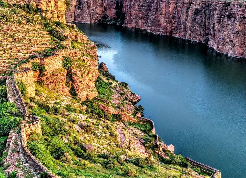 Discover dramatic canyon forts on a road trip to Unesco Hampi in India, a journey that also features wonders like the Lepakshi hanging pillar and Hampi's historic queens baths.