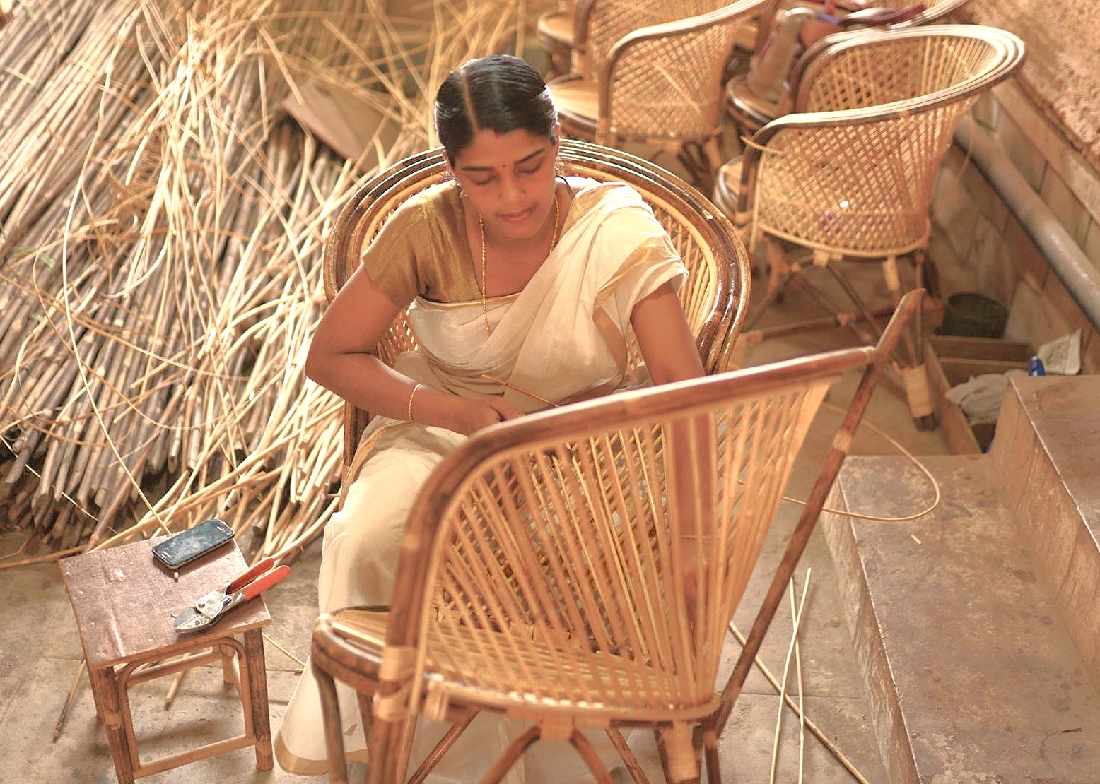 A local weaver in Madurai, Tamil Nadu, demonstrates the intimate relationship with traditional craftsmanship, a cultural experience for tourists visiting India near Meenakshi Temple, Munnar, and the Unesco Western Ghats.