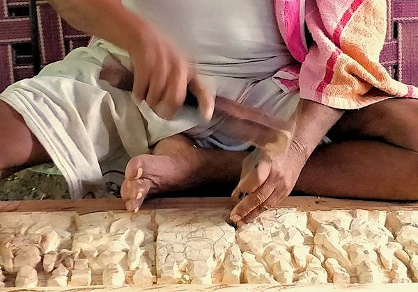 An artisan meticulously carves a wooden relief using traditional tools, representing the local craft skills found at the Marble Cottage in Agra, India near the UNESCO Taj Mahal and Keoladeo National Park. An artisan meticulously carves a wooden relief using traditional tools, representing the local craft skills found at the Marble Cottage in Agra, India near the UNESCO Taj Mahal and Keoladeo National Park.