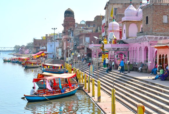 Experience the vibrant cultural riverside in Mathura, India, between Delhi and Agra, showcasing historic ghats, colorful boats, and scenic views near the majestic Taj Mahal and the imposing Agra Fort. Experience the vibrant cultural riverside in Mathura, India, between Delhi and Agra, showcasing historic ghats, colorful boats, and scenic views near the majestic Taj Mahal and the imposing Agra Fort.
