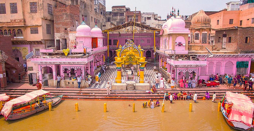 Vibrant Hindu devotees gather along the riverbank at a pink temple complex in Mathura, India, near Delhi, close to Agra and the iconic Taj Mahal, showcasing colorful architecture and rituals. Vibrant Hindu devotees gather along the riverbank at a pink temple complex in Mathura, India, near Delhi, close to Agra and the iconic Taj Mahal, showcasing colorful architecture and rituals.