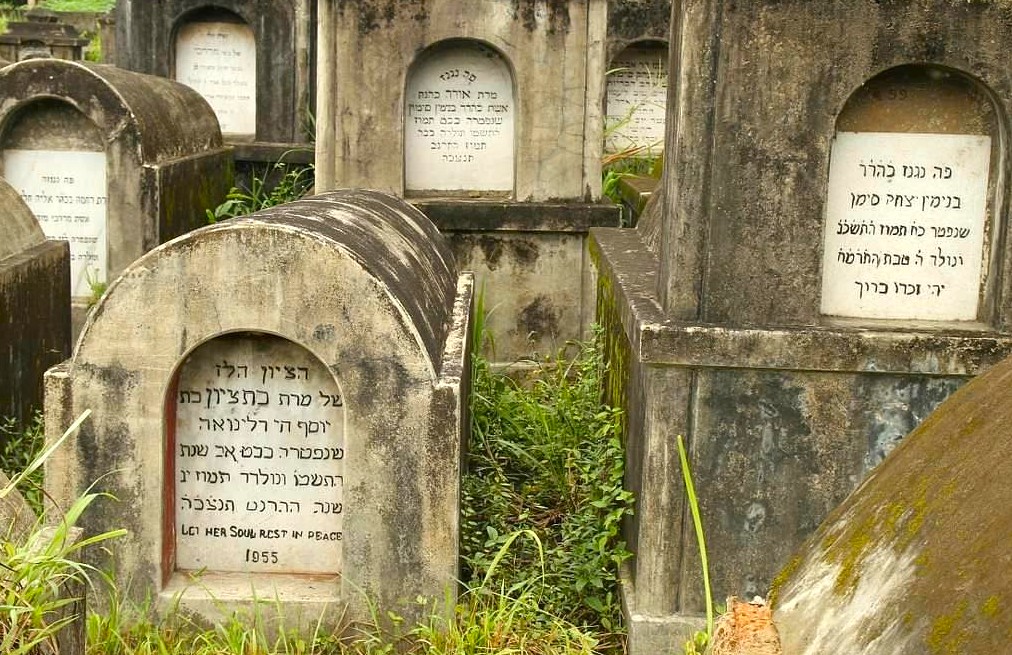 Jewish cemetery with weathered Hebrew-inscribed tombstones amidst overgrown greenery near Kochi’s Mattancherry Palace in Kerala, South India, preserving centuries-old rich cultural heritage while reflecting the region’s religious and architectural legacy. Jewish cemetery with weathered Hebrew-inscribed tombstones amidst overgrown greenery near Kochi’s Mattancherry Palace in Kerala, South India, preserving centuries-old rich cultural heritage while reflecting the region’s religious and architectural legacy.