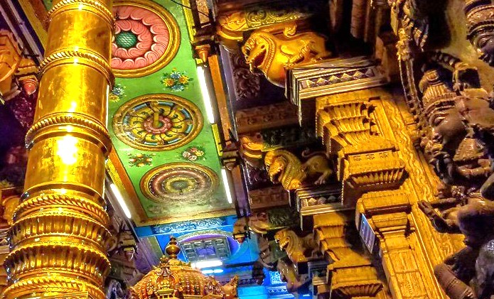 Intricate golden pillars, vibrant floral ceiling murals, and ornate lion motifs characterize the interior of the ancient Meenakshi Temple in Madurai, Tamil Nadu, South India, reflecting centuries-old Dravidian temple architecture. Intricate golden pillars, vibrant floral ceiling murals, and ornate lion motifs characterize the interior of the ancient Meenakshi Temple in Madurai, Tamil Nadu, South India, reflecting centuries-old Dravidian temple architecture.