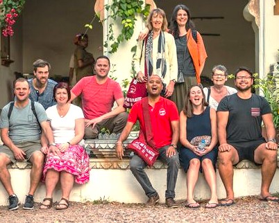 A group of international tourists enjoys a guided tour in India, visiting historic landmarks like the Meguti Temple in Aihole, Karnataka, located near Badami and the Pattadakal UNESCO site. A group of international tourists enjoys a guided tour in India, visiting historic landmarks like the Meguti Temple in Aihole, Karnataka, located near Badami and the Pattadakal UNESCO site.