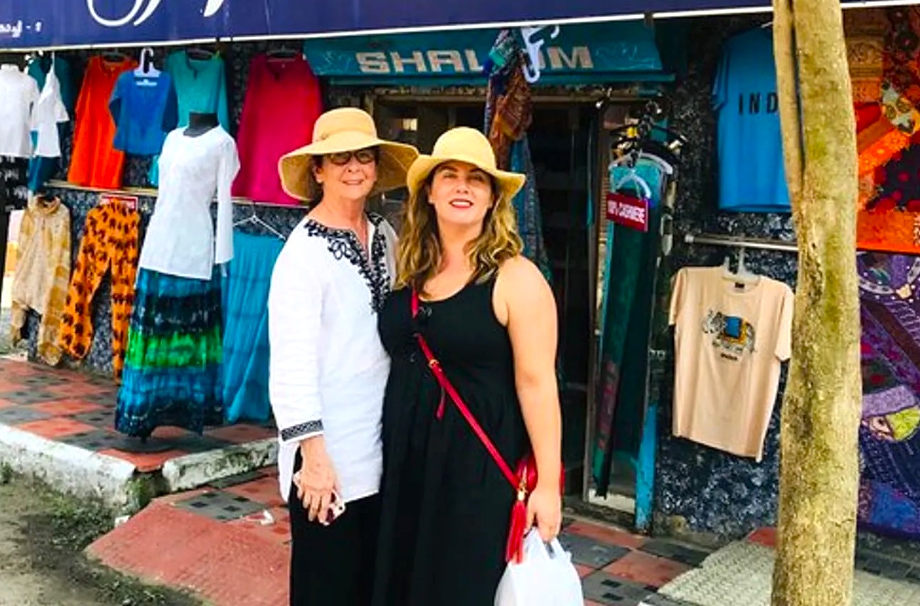 Two women wearing straw hats shopping at vibrant authentic local boutique near Mehrangarh Fort in Jodhpur, Rajasthan, India, showcase summer fashion, colorful displays, street shopping tour, cultural tourism, retail experience. Two women wearing straw hats shopping at vibrant authentic local boutique near Mehrangarh Fort in Jodhpur, Rajasthan, India, showcase summer fashion, colorful displays, street shopping tour, cultural tourism, retail experience.