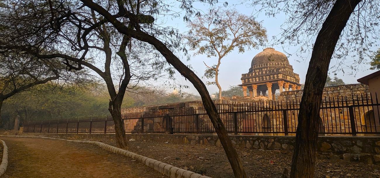 Explorers wander through ancient ruins and verdant pathways at Mehrauli Archaeological Park in Delhi, India, marveling at Mughal architecture, historic monuments, serene gardens, centuries-old Indo-Islamic heritage, and urban skyline views. Explorers wander through ancient ruins and verdant pathways at Mehrauli Archaeological Park in Delhi, India, marveling at Mughal architecture, historic monuments, serene gardens, centuries-old Indo-Islamic heritage, and urban skyline views.