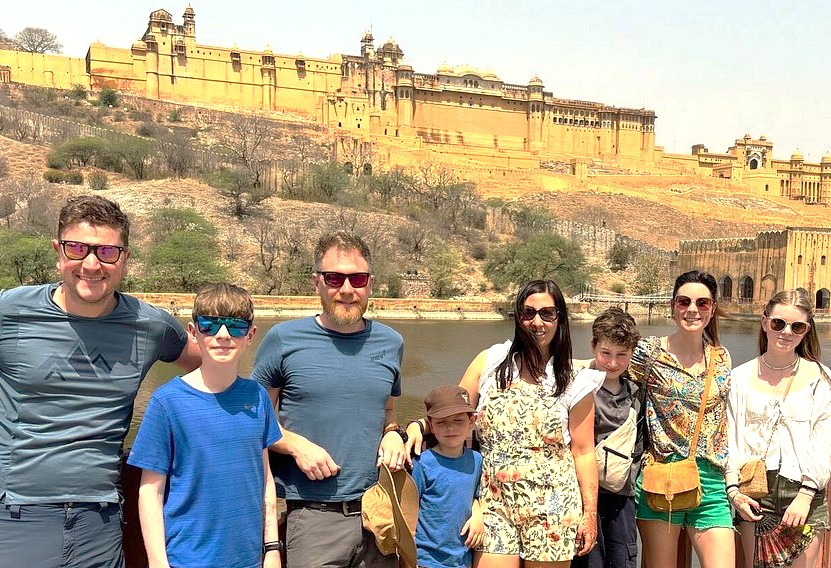 Group of nine tourists strolling by the river near Galta Ji Monkey Temple in Jaipur, Rajasthan, India, enjoying panoramic views, historic architecture, hillside fort, vibrant cultural heritage, and sunny sightseeing. Group of nine tourists strolling by the river near Galta Ji Monkey Temple in Jaipur, Rajasthan, India, enjoying panoramic views, historic architecture, hillside fort, vibrant cultural heritage, and sunny sightseeing.