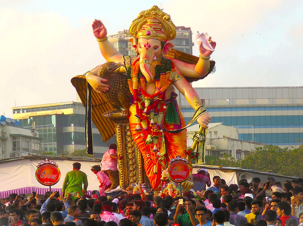 A massive Lord Ganesha idol procession during the Ganesh Chaturthi festival in Mumbai, Maharashtra, India, a city-wide celebration with events near landmarks like Dhobi Ghat and UNESCO's Elephanta Caves. A massive Lord Ganesha idol procession during the Ganesh Chaturthi festival in Mumbai, Maharashtra, India, a city-wide celebration with events near landmarks like Dhobi Ghat and UNESCO's Elephanta Caves.
