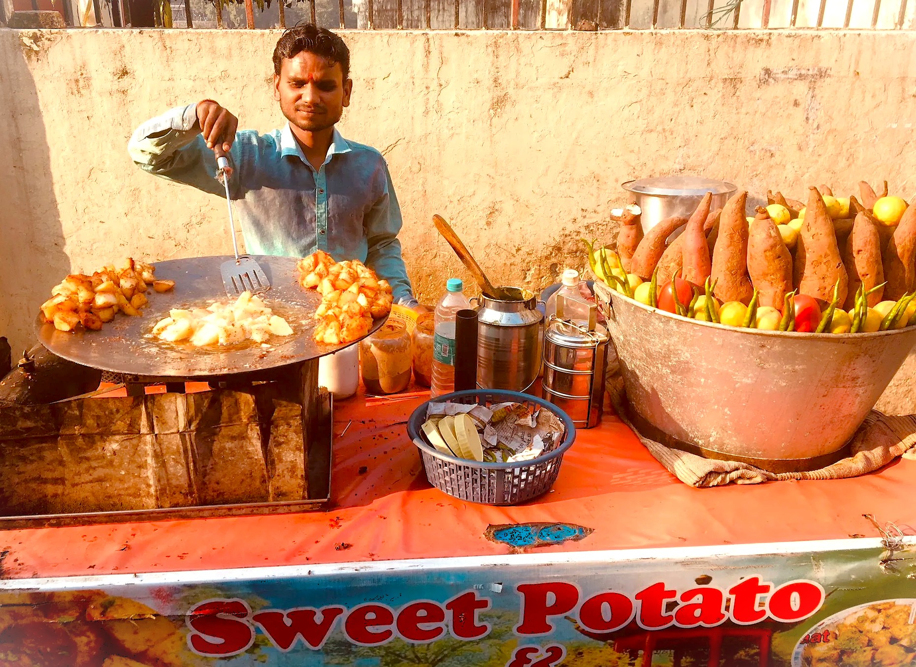 A street food vendor in Mumbai, Maharashtra, India, prepares sweet potato chaat—a popular snack often enjoyed near bustling landmarks like Dhobi Ghat and the ferry to UNESCO's Elephanta Caves. A street food vendor in Mumbai, Maharashtra, India, prepares sweet potato chaat—a popular snack often enjoyed near bustling landmarks like Dhobi Ghat and the ferry to UNESCO's Elephanta Caves.